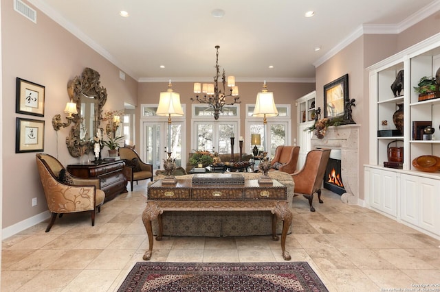 sitting room with an inviting chandelier, crown molding, and french doors