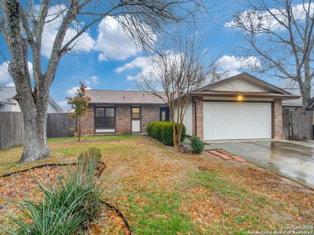 ranch-style house featuring a garage and a front lawn