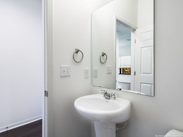 bathroom with hardwood / wood-style flooring and sink