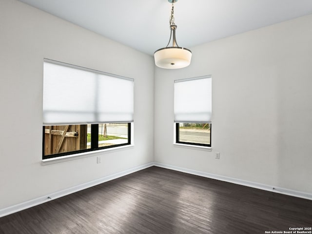 unfurnished room featuring dark hardwood / wood-style flooring