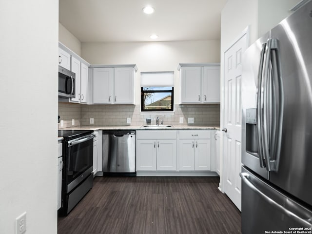 kitchen featuring white cabinetry, appliances with stainless steel finishes, sink, and backsplash