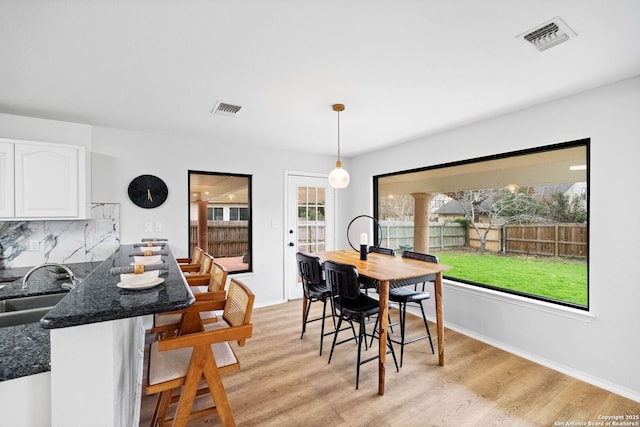 dining room featuring sink and light hardwood / wood-style floors