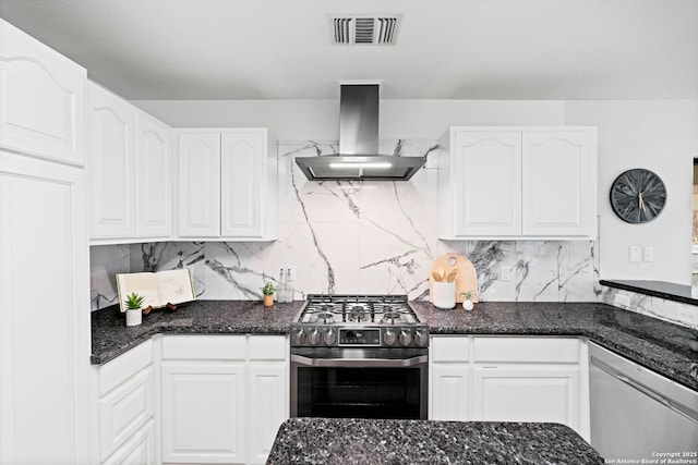 kitchen featuring white cabinetry, decorative backsplash, island exhaust hood, and appliances with stainless steel finishes