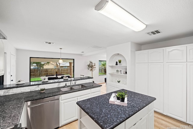 kitchen with sink, white cabinetry, dishwasher, a kitchen island, and pendant lighting