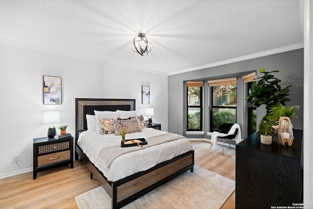 bedroom with a notable chandelier, ornamental molding, a textured ceiling, and light wood-type flooring