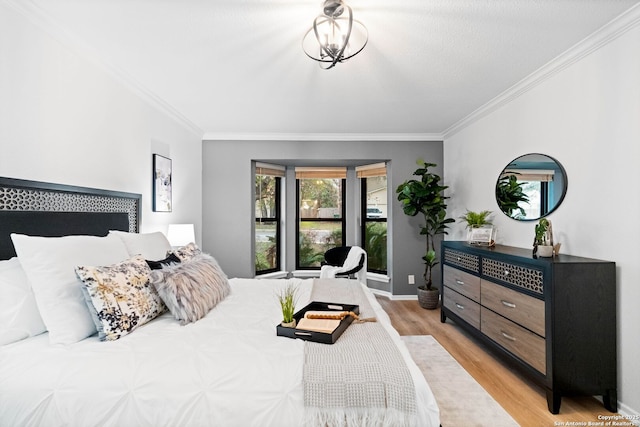 bedroom featuring ornamental molding and light wood-type flooring