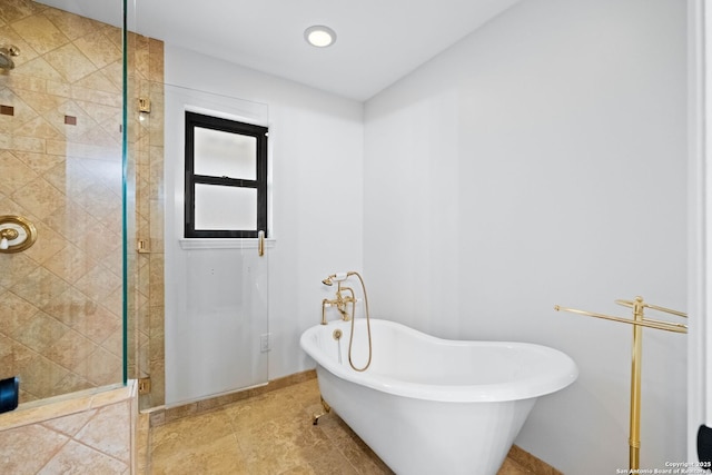 bathroom featuring shower with separate bathtub