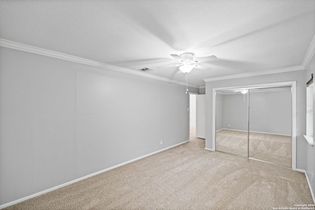 unfurnished bedroom featuring ornamental molding, carpet flooring, and a textured ceiling