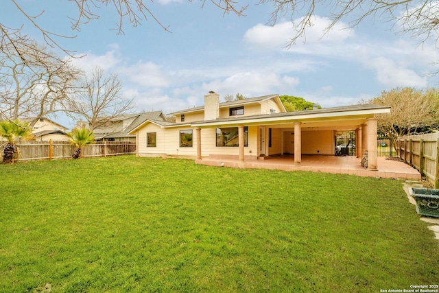 rear view of house with a patio area and a lawn