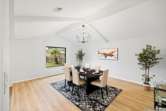 dining area with a notable chandelier, wood-type flooring, and vaulted ceiling with beams