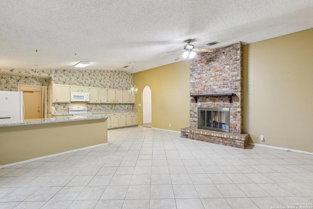 unfurnished living room featuring light tile patterned flooring, lofted ceiling, a brick fireplace, a textured ceiling, and ceiling fan