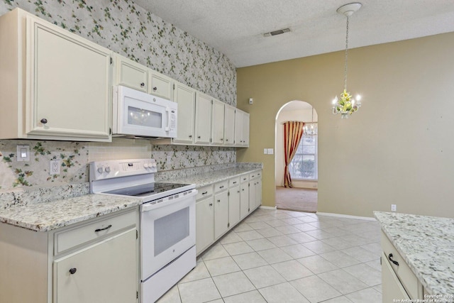 kitchen featuring decorative light fixtures, a textured ceiling, light tile patterned floors, white appliances, and white cabinets