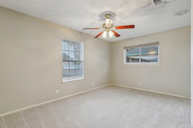 unfurnished room featuring ceiling fan, carpet flooring, and a textured ceiling