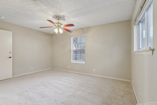 empty room featuring light carpet, a textured ceiling, and ceiling fan