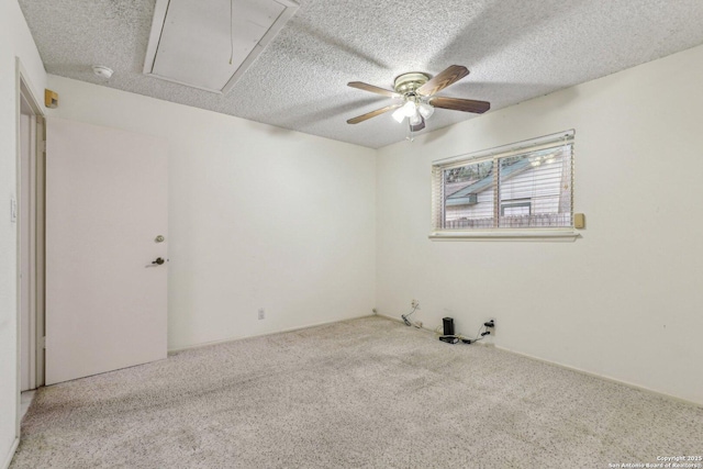 unfurnished room with ceiling fan, light colored carpet, and a textured ceiling