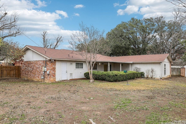 back of house with a lawn