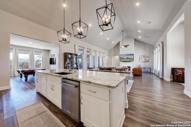 kitchen with sink, a kitchen island with sink, hanging light fixtures, dark hardwood / wood-style floors, and white cabinets