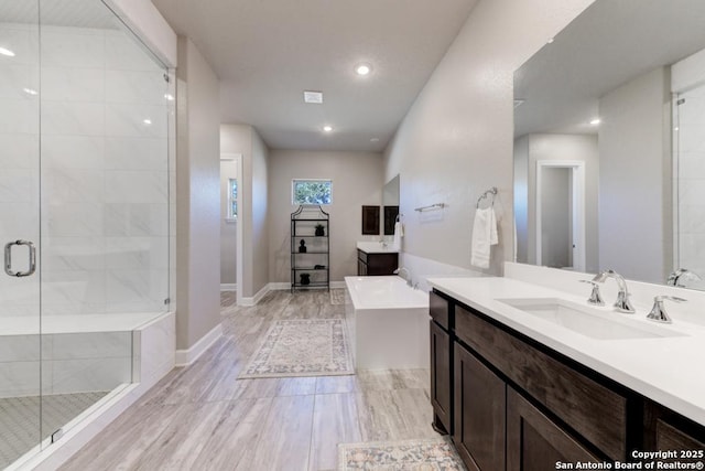 bathroom with vanity and independent shower and bath