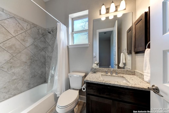 full bathroom with vanity, shower / tub combo, and toilet