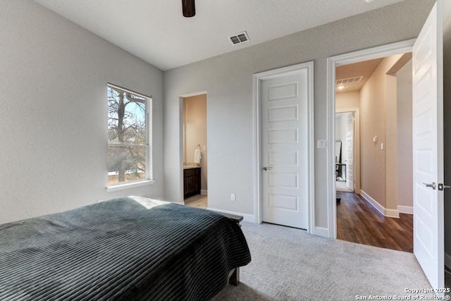 bedroom featuring connected bathroom, carpet floors, and ceiling fan