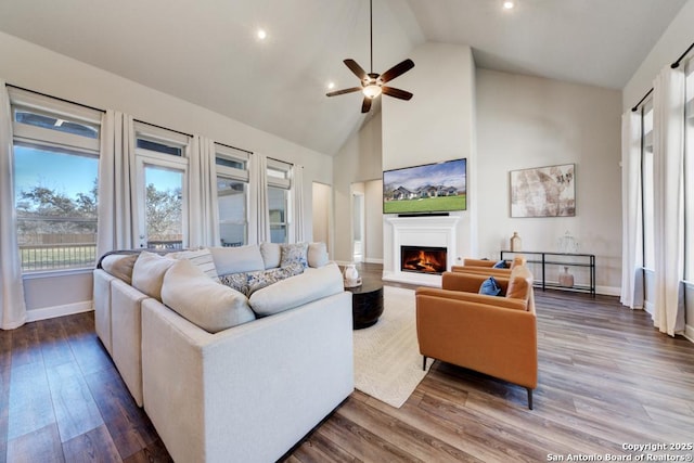 living room featuring ceiling fan, high vaulted ceiling, and hardwood / wood-style floors