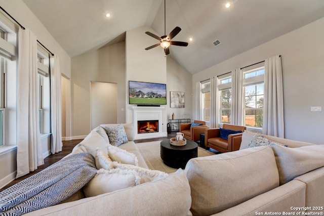 living room featuring ceiling fan, hardwood / wood-style floors, and high vaulted ceiling