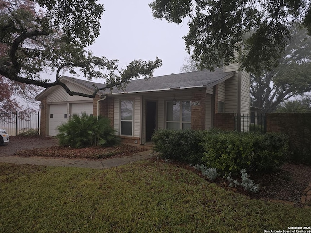 ranch-style house with a garage and a front yard