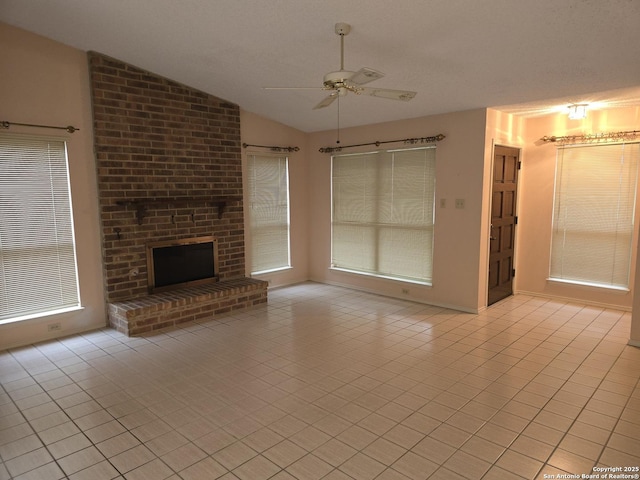 unfurnished living room featuring vaulted ceiling, a brick fireplace, light tile patterned floors, and ceiling fan