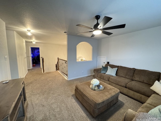 living room featuring ceiling fan and carpet