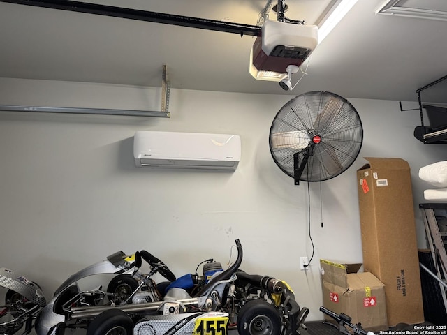 garage featuring a garage door opener and a wall mounted AC