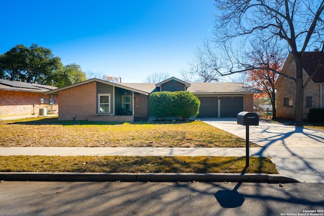 ranch-style home with a garage, central air condition unit, and a front lawn