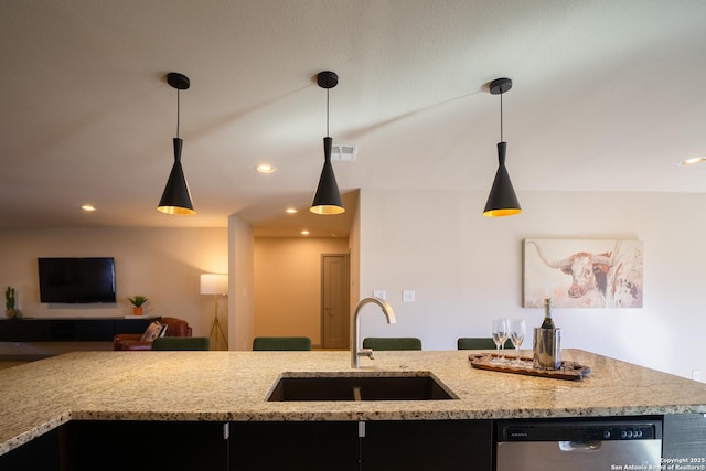 kitchen featuring pendant lighting, dishwasher, sink, and light stone countertops