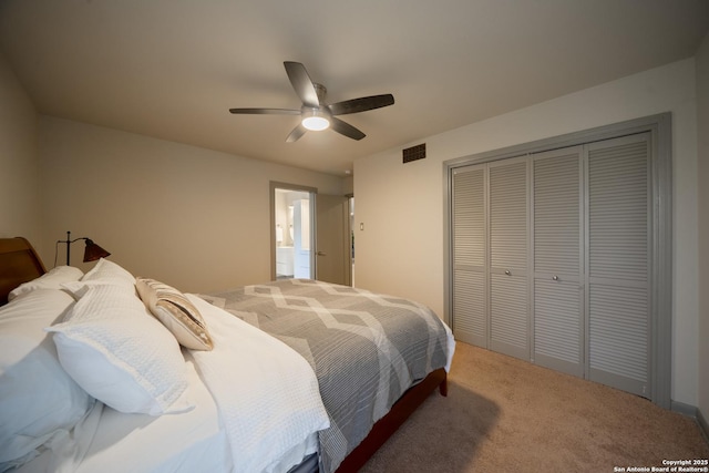 carpeted bedroom featuring ceiling fan and a closet