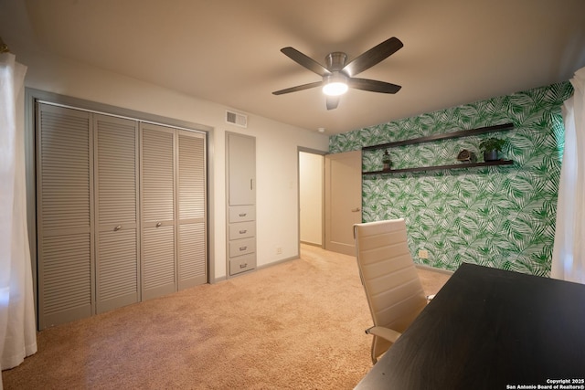 home office with light carpet and ceiling fan