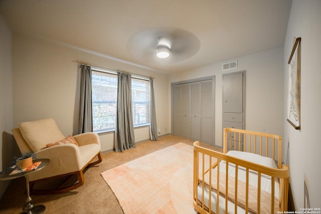 bedroom with light carpet, a closet, and ceiling fan