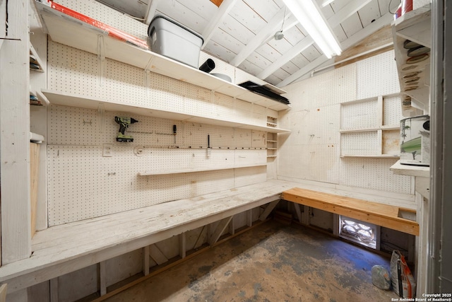 mudroom featuring lofted ceiling and a workshop area