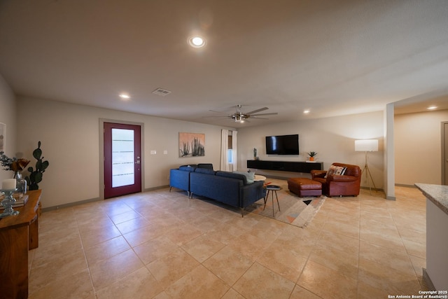 living room featuring light tile patterned floors and ceiling fan