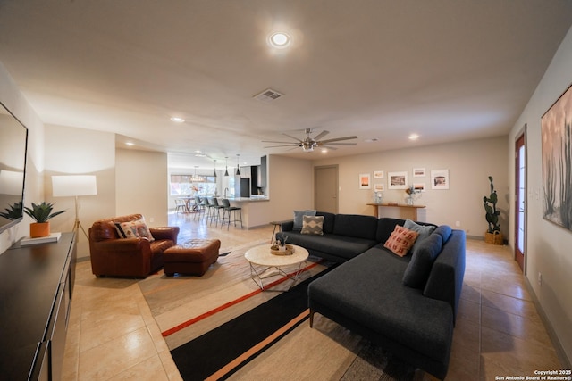 tiled living room with ceiling fan