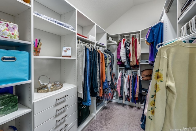 spacious closet featuring vaulted ceiling and carpet