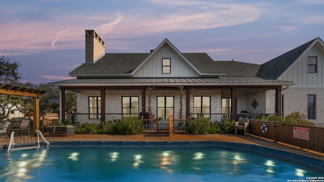 view of pool at dusk