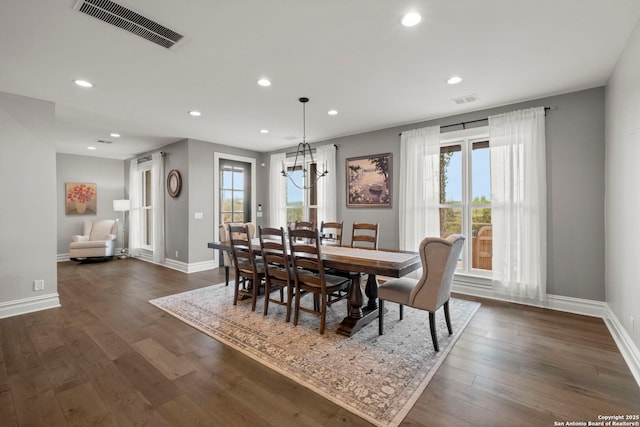 dining room featuring an inviting chandelier and dark hardwood / wood-style floors