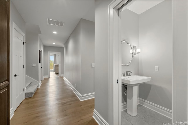 bathroom with wood-type flooring and sink