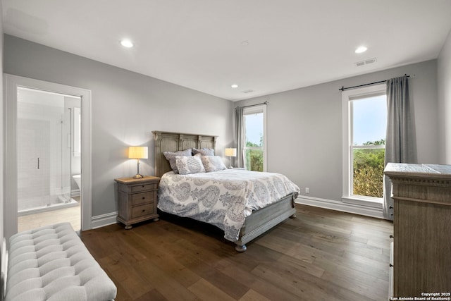 bedroom with connected bathroom and dark hardwood / wood-style flooring