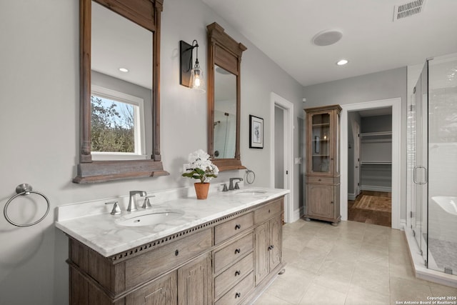 bathroom with vanity, tile patterned flooring, and a shower with door