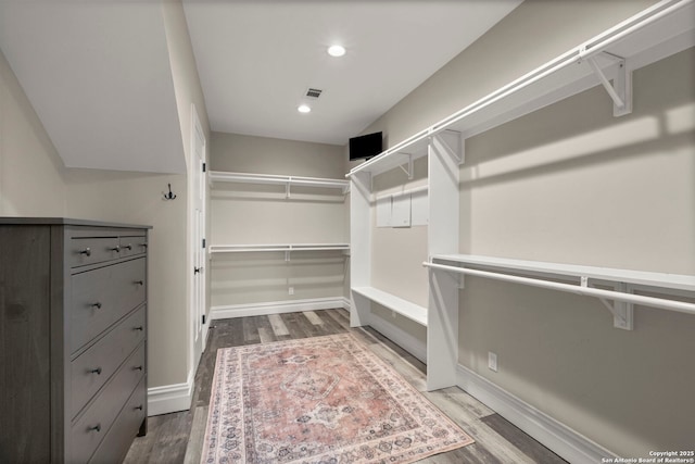 walk in closet featuring hardwood / wood-style flooring