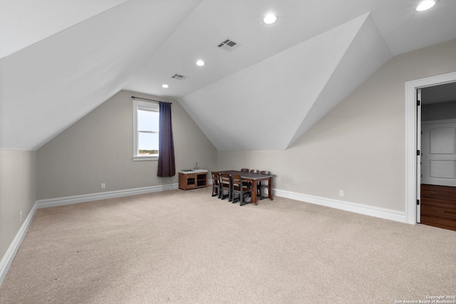 additional living space with lofted ceiling and carpet floors