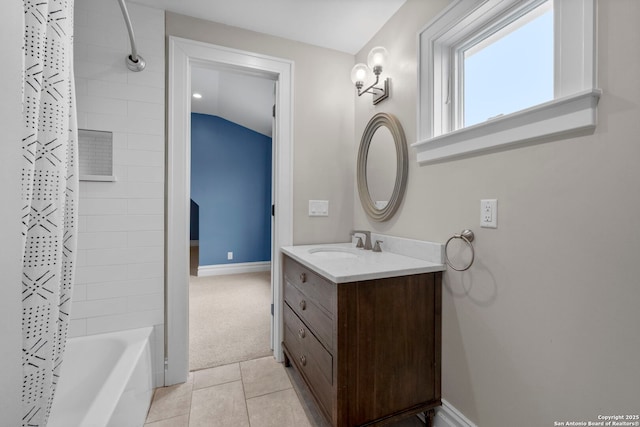 bathroom featuring shower / bath combination with curtain, lofted ceiling, vanity, and tile patterned flooring