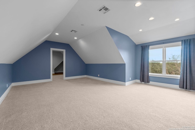 bonus room featuring light colored carpet and lofted ceiling