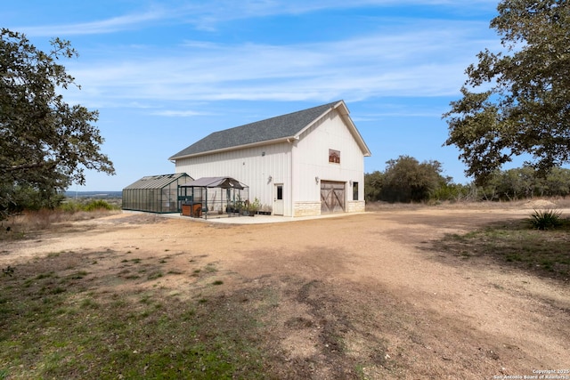 view of side of property with an outdoor structure