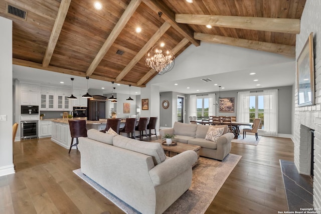 living room featuring high vaulted ceiling, a brick fireplace, wooden ceiling, beamed ceiling, and light wood-type flooring